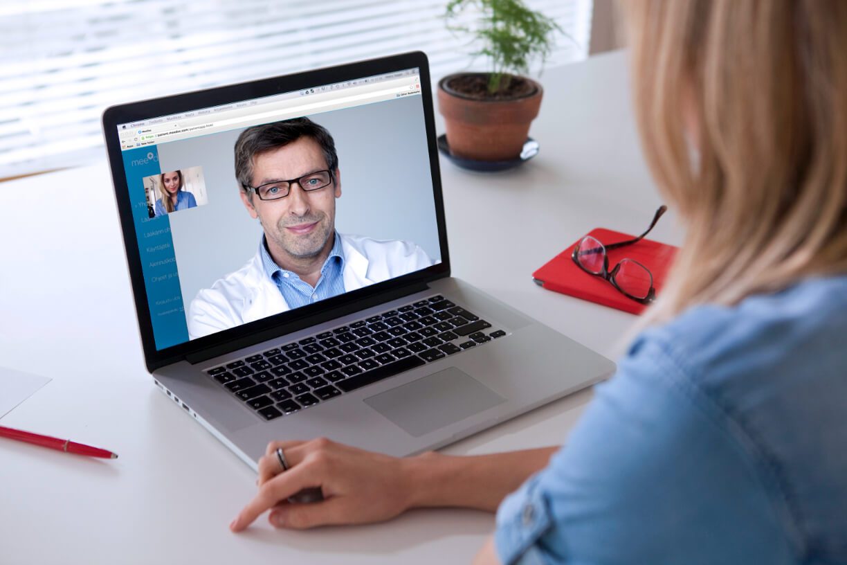 A woman is using management software on a laptop.