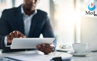 A man in a suit is using a tablet computer to access management software.